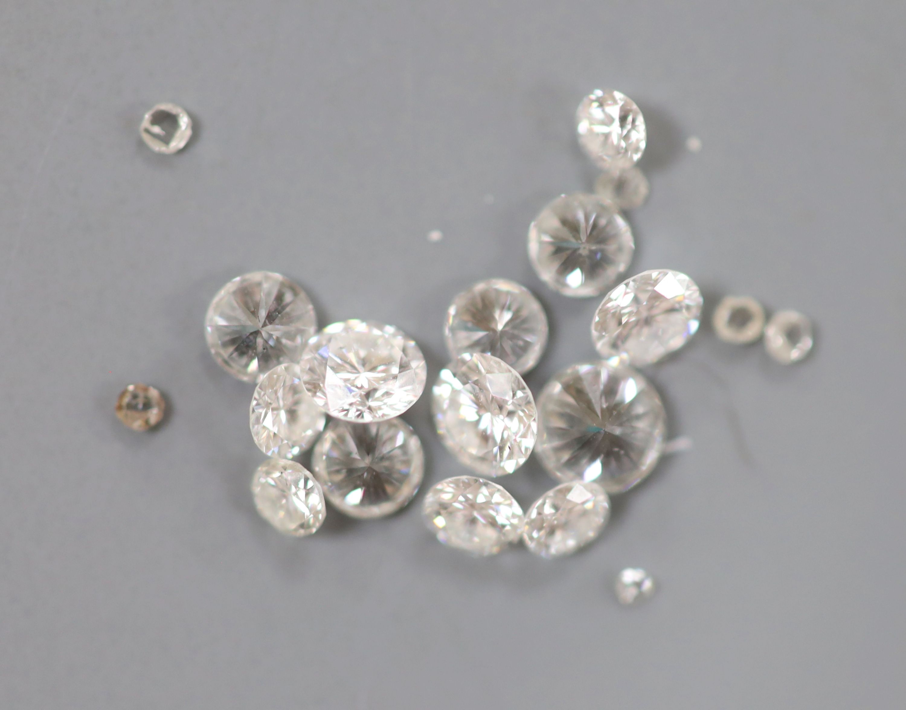 Thirteen unmounted round brilliant cut diamonds, weighing approximately 1.30ct in total and a quantity of tiny unmounted diamonds.